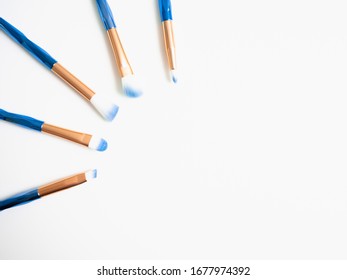 Classic Blue Eyeshadow Brushes Isolated On White Background With Space For Copy Space.