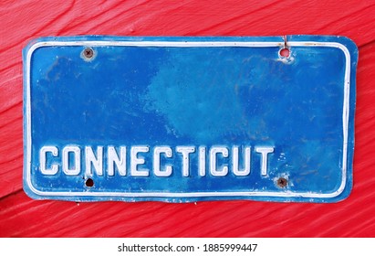 Classic Blue License Plate Of Connecticut On Wooden Red Background.