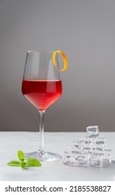 Classic Boulevardier Or Cinquecento Alcoholic Cocktail With Campari, Rye Whiskey And Sweet Vermouth With Zest Of Orange On A Grey Background