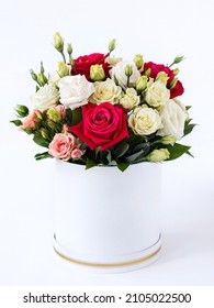 classic bouquet of flowers in a white box on a white background, close-up with a blurred background. big red roses, pink and white bush roses, white eustoma, greenery as a valentine's day gift - Shutterstock ID 2105022500