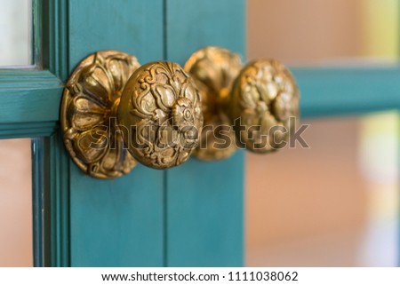 Classic brass door knob on green door vintage style