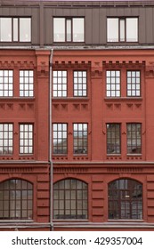 Classic brick facade with large windows.