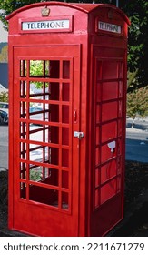 Classic British Red Phone Booth On A City Street. Traditional Red British Telephone Box. Historical Architecture. Nobody, Travel Photo, Selective Focus