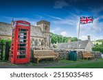 A classic British village with church, red telephone booth and Union Jack