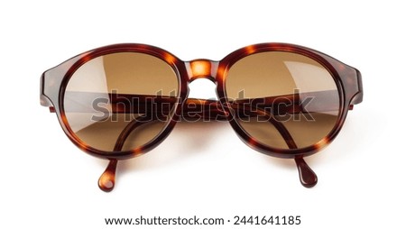 classic brown retro vintage style sunglasses with tortoise colored frame isolated over a white background, stylish fashion or lifestyle element, top view
