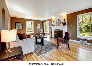 Classic Brown And White Living Room Interior With Hardwood Floor.