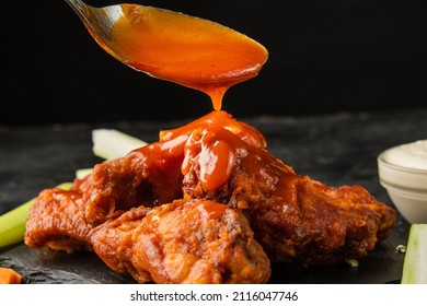 Classic buffalo wings topped with sauce. BBQ wings. - Shutterstock ID 2116047746