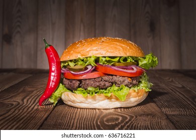 Classic Burger And Red Pepper On Wooden Table.