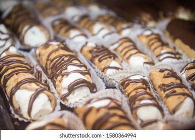 Classic Cannolis filled with sweet cream and chocolate drizzles