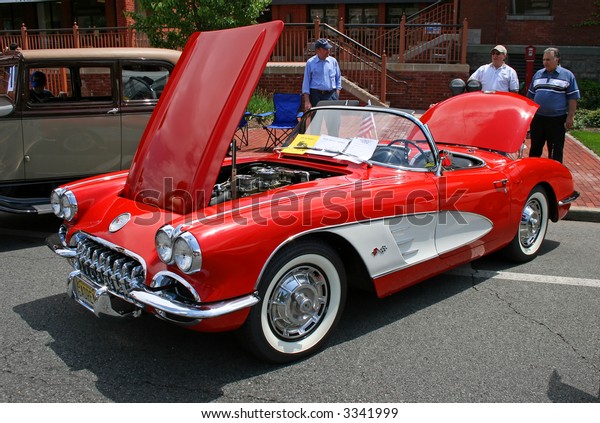 A\
classic car displayed at a street antique car\
show