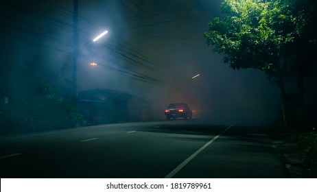 Classic car drive into abandoned road with large group of smoke and ghost town concept - Powered by Shutterstock