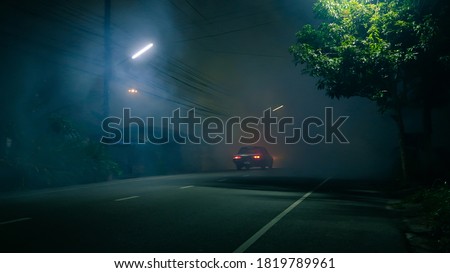 Classic car drive into abandoned road with large group of smoke and ghost town concept