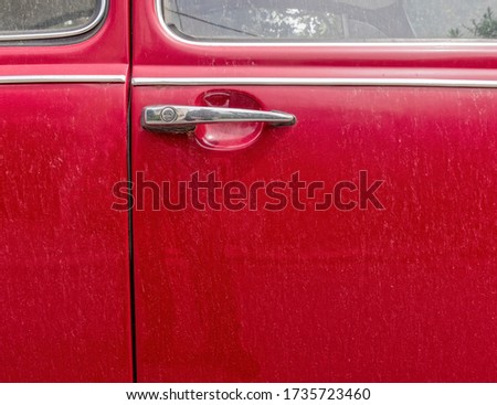 classic car shiny handle and red door partial view, space for your text
