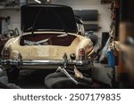 Classic cars being restored in a vintage vehicle garage workshop