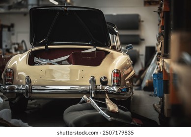 Classic cars being restored in a vintage vehicle garage workshop - Powered by Shutterstock