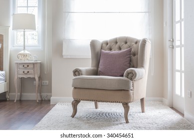 Classic Chair On Carpet With Pillow In Bedroom