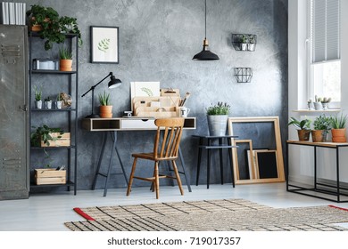 Classic Chair At White Desk Against Concrete Wall In Home Office With Plants