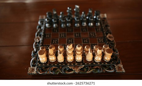 A classic chess setup with intricately designed light and dark wooden pieces on an elaborate board.