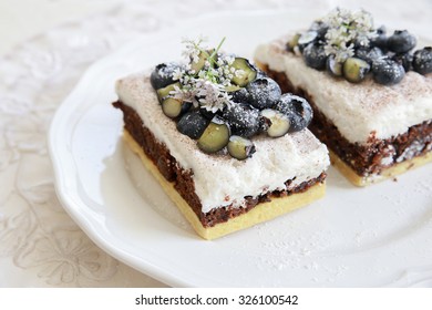 Classic Chester Cake Slices With Blueberries And Cilantro Flowers On White Plate