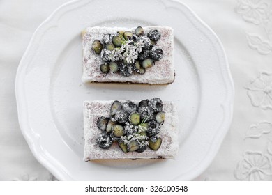 Classic Chester Cake Slices With Blueberries And Cilantro Flowers On White Plate