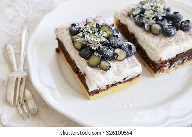 Classic Chester Cake Slices With Blueberries And Cilantro Flowers On White Plate