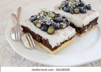 Classic Chester Cake Slices With Blueberries And Cilantro Flowers On White Plate