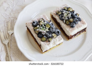 Classic Chester Cake Slices With Blueberries And Cilantro Flowers On White Plate