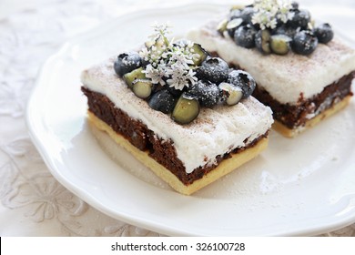 Classic Chester Cake Slices With Blueberries And Cilantro Flowers On White Plate