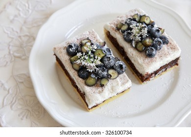 Classic Chester Cake Slices With Blueberries And Cilantro Flowers On White Plate