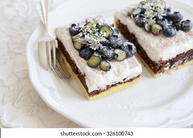 Classic Chester Cake Slices With Blueberries And Cilantro Flowers On White Plate