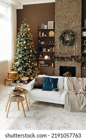 Classic Christmas Interior In The Living Room With A Sofa, Brown Walls, Large Windows, Fireplace And Shelves With Decor. Cozy New Year's Interior With A Christmas Tree And A Wreath Over The Fireplace