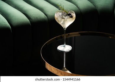 Classic Cocktail Glass On Glass Table In Night Club Restaurant. Alcohol Cocktail Drink, Close-up. Modern Alcoholic Beverage