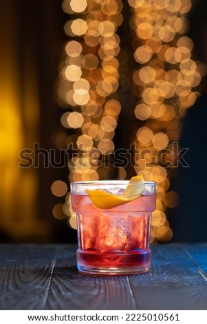 Classic Cocktail Negroni short drink with gin, campari martini rosso and orang at the bar