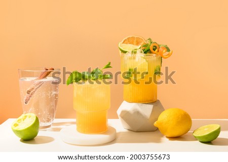 Classic cocktails, lemonade, mai tai, mojito with lime on modern still life with podium on a beige background. for Summer freshness beverage.