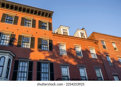 An classic colonial multistory red brick apartment strict geometric shape building with living quarters in the attic and forged balconies in the Cambridge city limit in Massachusetts in New England - Shutterstock ID 2254253925