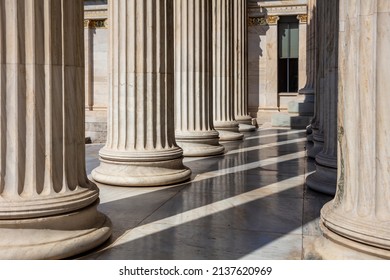 Classic columns pillars white marble. Athens Greece Academy neoclassical building entrance colonnade. Classical pillars in a row.