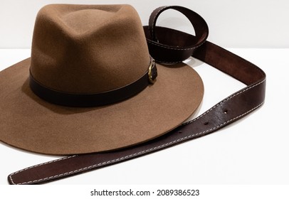 Classic Cowboy Brown Felt Hat And Leather Belt On White Background