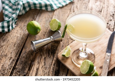 Classic daiquiri cocktail in glass on rustic wooden table. Copy space