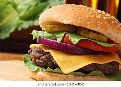 Classic deluxe cheeseburger with lettuce, onions, tomato and pickles on a sesame seed bun.  Macro with shallow dof.