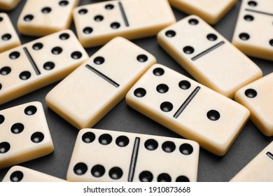 Classic domino tiles on black background, closeup