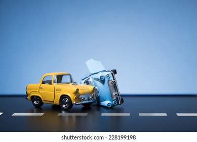 Classic fifties scale model toy cars accident on the road. - Shutterstock ID 228199198