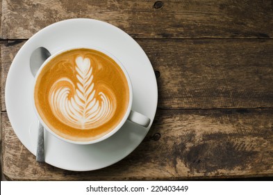 Classic Foamy Cappuccino On Dark Grained Wood Table From Above