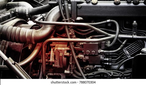 A classic fragment of diesel car engine or truck engine with copy space for text. Metallic background of the internal diesel truck engine or car engine.