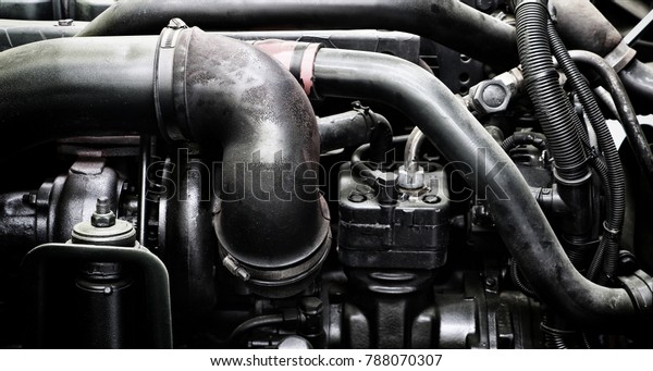 A classic fragment of diesel car\
engine or truck engine with copy space for text. Metallic\
background of the internal diesel truck engine or car\
engine.