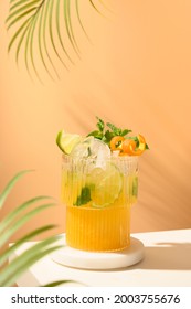 Classic Freshness Cocktail, Mojito, Lemonade Or Mai Tai With Lime, Orange On Modern Still Life On Podium On Beige Background With Shadow. Festive Party. Summer Holiday Mocktail.