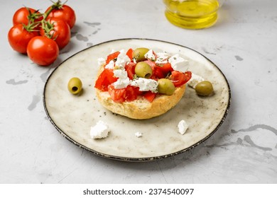 Classic Greek cuisine, dakos, toasted bun, topped with tomatoes, cheese or cottage cheese and olive oil. - Powered by Shutterstock