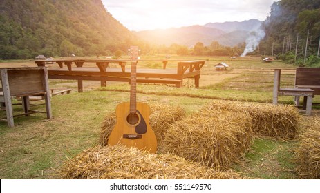 Classic guitar lying in front of the nature as background