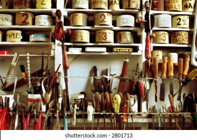 Classic handyman's workshop, with vintage hand tools and well-organized tins of nails, screws, etc.