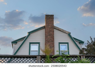 Classic home design with central brick chimney on a late summer afternoon in Brighton, Massachusetts, USA