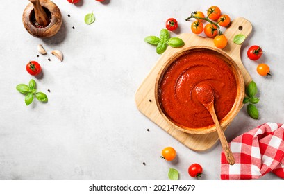 Classic homemade Italian tomato sauce with basil for pasta and pizza. Light gray stone  background. top view - Powered by Shutterstock